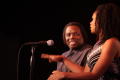 Photograph: [Curtis King smiles as Kimberly Elise talks into mic]