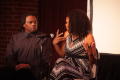 Photograph: [Kimberly Elise moves her hands while looking at Curtis King]