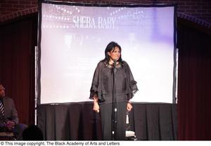 Primary view of object titled '[Pam Grier talks on stage in front of mic]'.