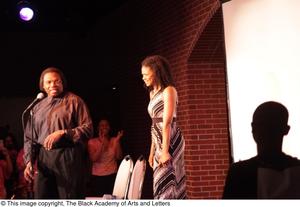 Primary view of object titled '[Kimberly Elise looks into crowd behind Curtis King]'.