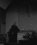 Photograph: [Photograph of Dr. Marshall E. Hodge standing at church altar #2]