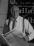 Thumbnail image of item number 1 in: '[Samuel Wick holding The Dallas Post Tribune]'.