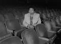 Photograph: [Dr. Versia Lacy seated in empty auditorium, 3]