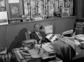 Photograph: [Lee Bilal seated in his office]