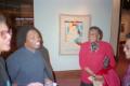 Primary view of [Curtis King laughing with guests at exhibition]