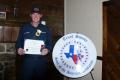 Photograph: [Arlington firefighters Kevin S. Pittmon posing with his certificate]