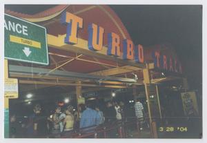 Primary view of object titled '[Photograph of an entrance to the "Turbo Track" attraction]'.