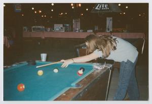 Primary view of object titled '[Photograph of TAMS student playing pool]'.