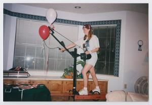 Primary view of object titled '[Photograph of a TAMS student on an exercise machine]'.