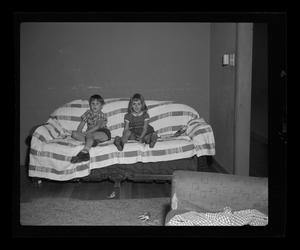 Primary view of object titled '[Byrd and Pam sitting on a couch]'.