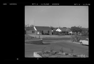 Primary view of object titled '[View of a neighborhood from a parking lot]'.