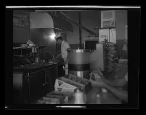 Primary view of object titled '[A cook at Ernie's Big Burger Cafe]'.
