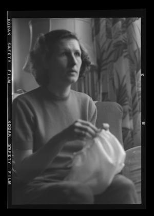 Primary view of object titled '[Doris Williams sitting on a sofa]'.