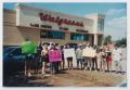 Primary view of [Photograph of TAMS students holding a car wash at a Walgreens]