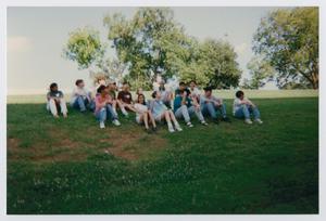 Primary view of object titled '[Photograph of TAMS students sitting on field]'.