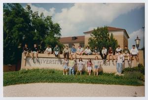 Primary view of object titled '[Photograph of TAMS students posing with UNT sign]'.