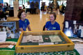 Thumbnail image of item number 1 in: '[Julie Judkins and Jaimi Parker at display table]'.