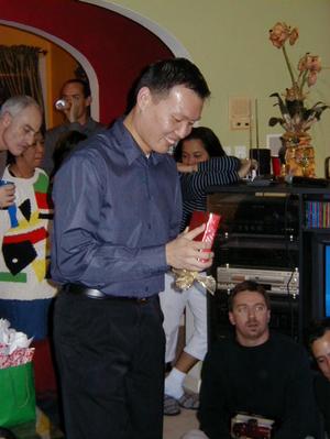 Primary view of object titled '[Guests opening gift at Mike and Tong's party]'.