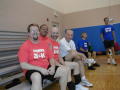 Photograph: [Members sitting in bleachers on court]