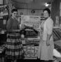 Photograph: [Two women standing in front of Cook Book Cakes display 2 of 2]