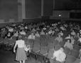 Photograph: [Audience sitting in seats]