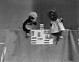 Photograph: [Puppets and a band-aid box]