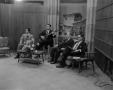 Primary view of [Four men seated on set]