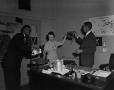 Photograph: [Hal Thompson and his secretary sharing a drink 1 of 4]
