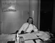 Photograph: [Man at desk on the phone]