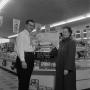Photograph: [Man and woman stand in front of store display at Cliff Food 2 of 2]