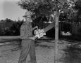 Photograph: [Calvin Pigg posing with a chainsaw]