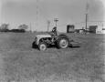 Thumbnail image of item number 1 in: '[Man on tractor in grass field]'.