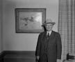 Photograph: [Howard Hugh in front of painting]