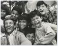 Photograph: [Photograph of a man with a group of kids]