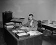 Primary view of [Thaine Engle at his desk]