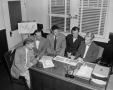 Photograph: [Photograph of five men in an office]