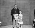 Photograph: [Bobby Peters with contest winner holding portrait]