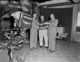 Photograph: [Photo of Doc Rhuman with Cal Johnson and TV weatherman]