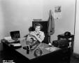 Photograph: [Barbara Pritchie seated behind a desk]