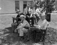 Photograph: [Photograph of men sitting outdoor]