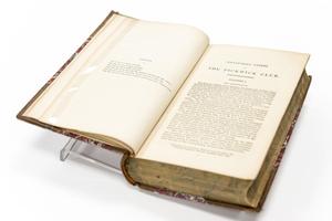 Top view of an open book, showing a small paragraph on the left page, and the first chapter on the right page.