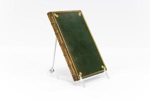 Book is propped up, the cover is a dark green with a gold rim