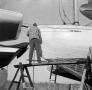 Photograph: [Photograph of an individual working on a boat]