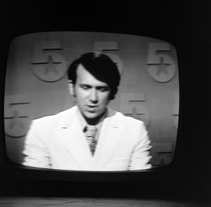 Primary view of object titled '[Ron Spain on television]'.