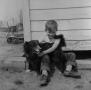 Photograph: [Photograph of Tim Williams sitting outside with a dog]