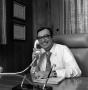Photograph: [Ron Godbey speaking on a telephone]