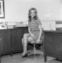Photograph: [Diana Miller with her legs crossed]