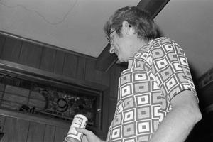 Primary view of object titled '[Russ Thornton holding a Budweiser]'.
