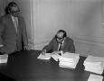 Photograph: [Abe Herman signing documents]