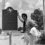 Photograph: [Don Shores with a historical marker]